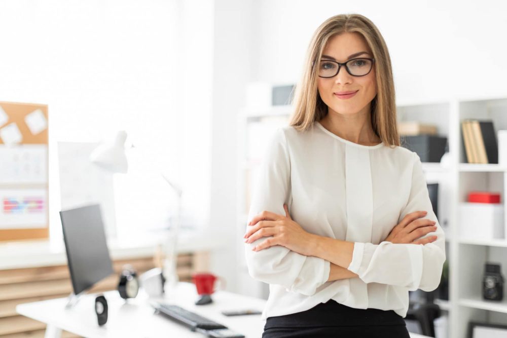 young-girl-is-standing-leaning-table-office